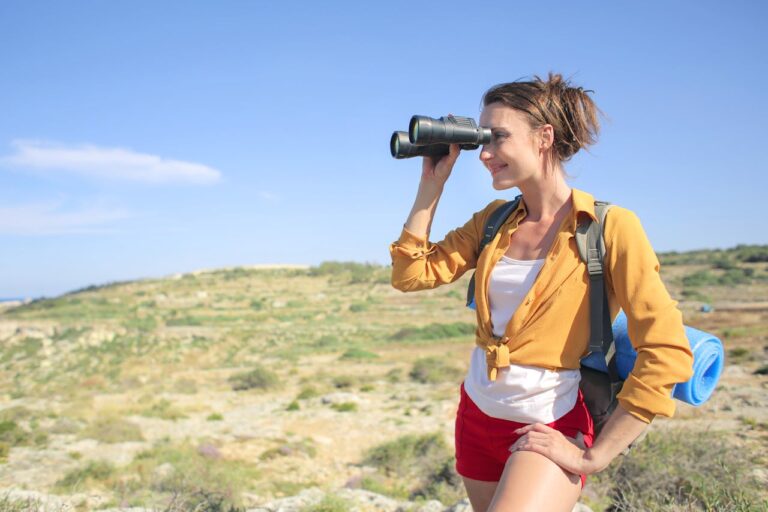 Home 3 Woman Looking Through Binoculars While Hiking